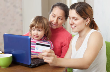 Fototapeta na wymiar Happy family shopping in internet from home