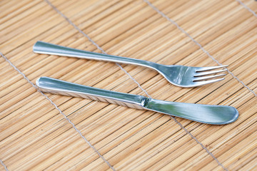 knife and fork on bamboo tray