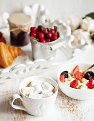 Healthy breakfast with cottage cheese, cacao, cherry and croissa