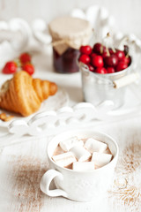 Obraz na płótnie Canvas Healthy breakfast with cottage cheese, cacao, cherry and croissa
