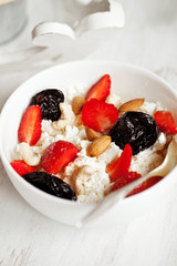 Healthy breakfast with cottage cheese, cacao, cherry and croissa