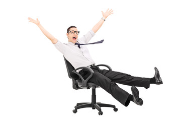 Man riding in an office chair and gesturing joy