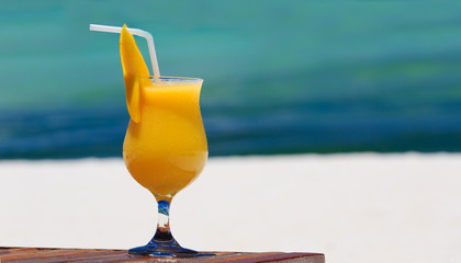 mango cocktail on tropical beach