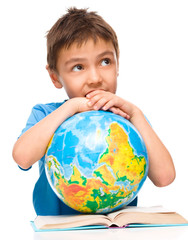 Little boy is holding globe