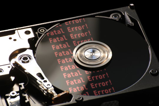 Hard disk on a black background, reflecting error message