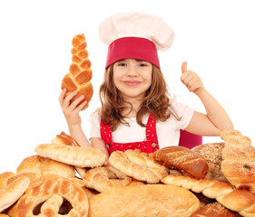 happy little girl cook with breads rolls and thumb up