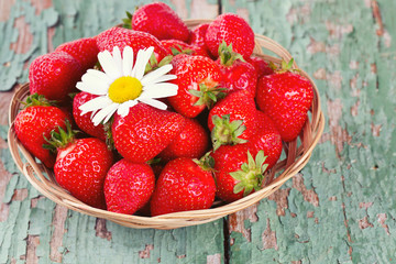 basket with strawberries on a wooden table
