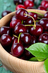 cherries in a bowl on wooden surface