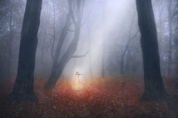 Ghostly girl playing the piano in a foggy forest
