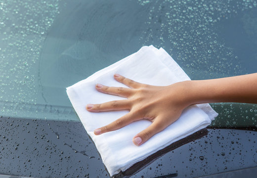 Young Girl Hand Wiping A Car Glass Dry