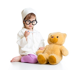 kid girl playing doctor with toy