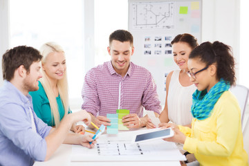 smiling interior designers working in office