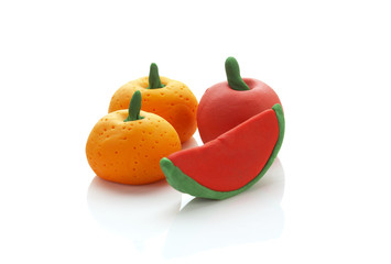 three fruit from clay on white background