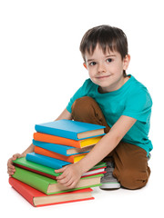 Smiling little boy with books