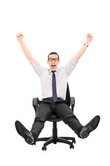 Overjoyed man riding in an office chair