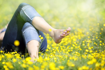 Woman lying in meadow relaxing