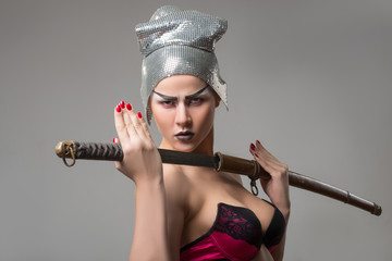 Beautiful girl in bra with katana