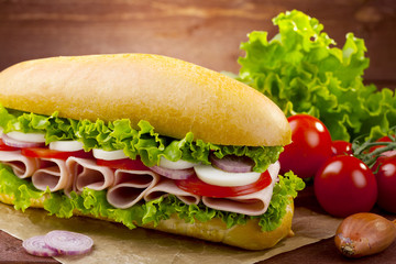 big sandwich with ham, cheese and vegetables