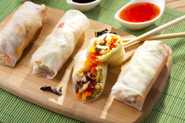 Portion of spring rolls on a bamboo board