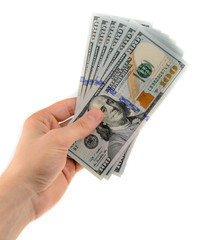 Man's hand holds a fan of dollars isolated on white background