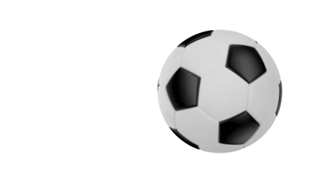 Soccer ball flies at the camera then stops but keeps rotating.