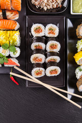 Delicious sushi pieces served on black stone