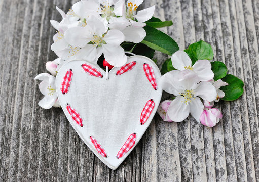 Spring Blossom and heart over wooden background
