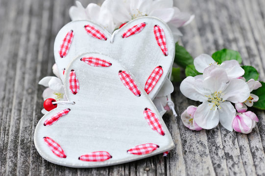 Spring Blossom and hearts over wooden background
