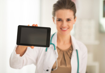 Closeup on medical doctor woman showing tablet pc blank screen