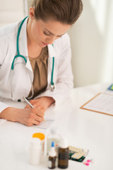 Medical doctor woman writing prescription