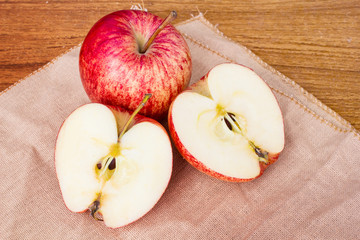 Fresh Apples lying on a Wooden Table.