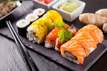 Delicious sushi pieces served on black stone