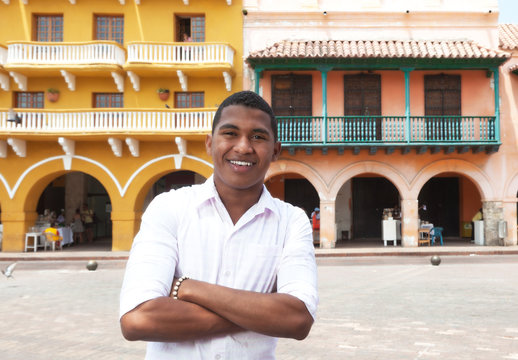 Young guy with crossed arms in a colonial town
