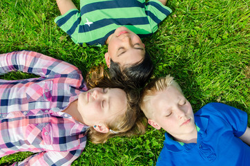 kinder liegen relaxt im gras