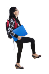 Fototapeta premium Student in pose stepping upward