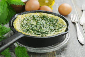 Omelet with nettles in the pan