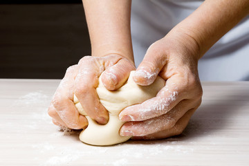 Hands kneading a dough