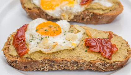 Closeup of Spanish Tapa with Fried egg and dry tomato