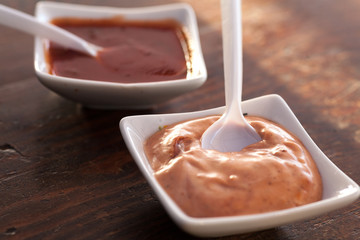 Two bowls of a delicious sauce on a table