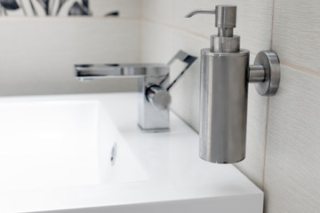 Chromium-plate tap on white sink.