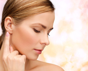 calm woman touching her ear