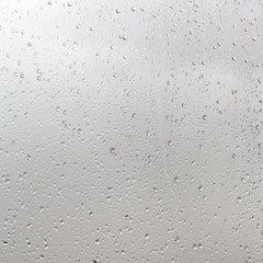 rain drops on window pane in cloudy day