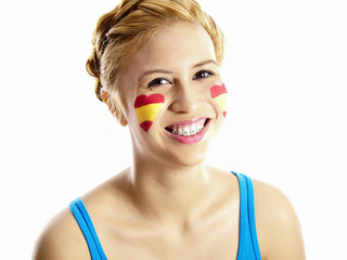 smiling girl with spanish flag painted on her face