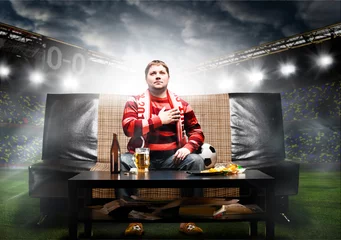Foto op Plexiglas soccer fan on sofa © Sergey Peterman