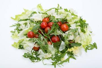 Heap of ruccola, lettuce leaves and cherry tomatoes