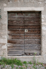 Old wooden door in stone wall