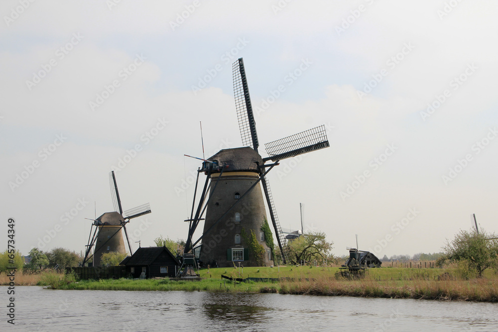 Wall mural windmills on the canal bank.