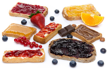 Some toasts with jams, honey and hazelnut spread