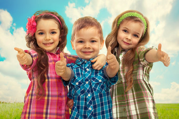 Cute fashion kids showing thumbs up
