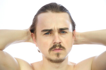 Obraz premium Attractive man with arms behind his head